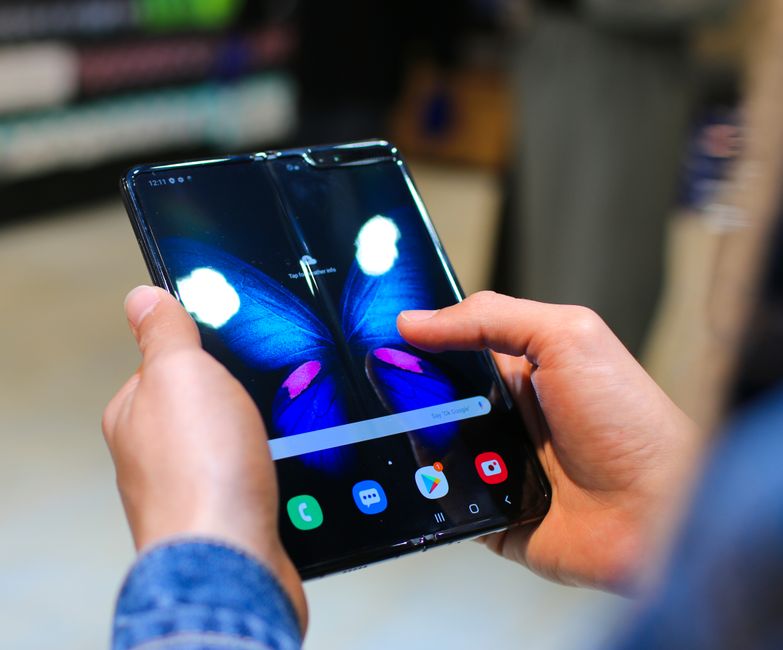 An open foldable smartphone lying on a table