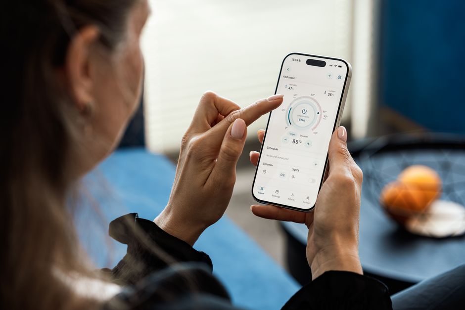 Hand holding an iPhone with the Settings app open